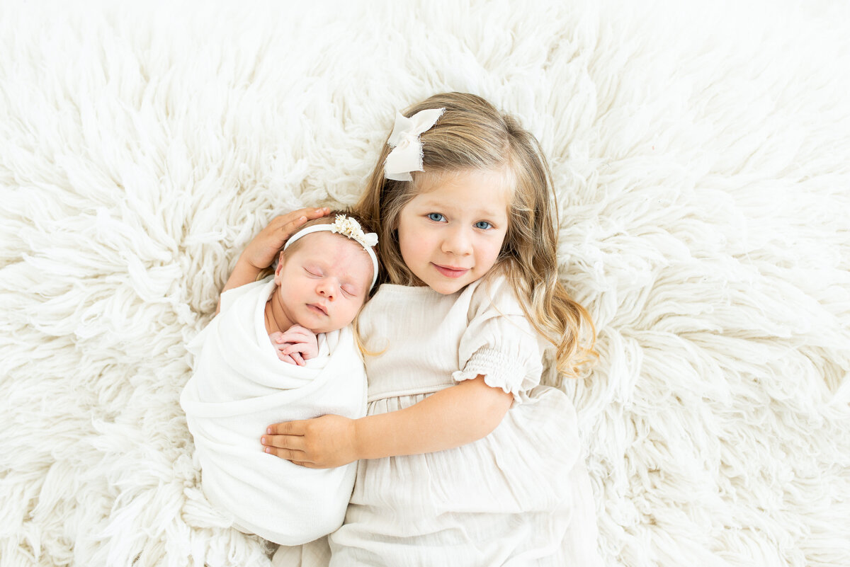 St. Louis Newborn Photography Sister holding baby