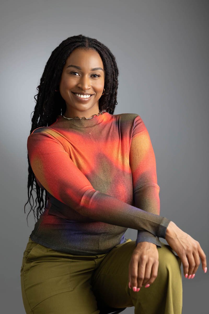 Beautiful woman with long braids smiling at the camera