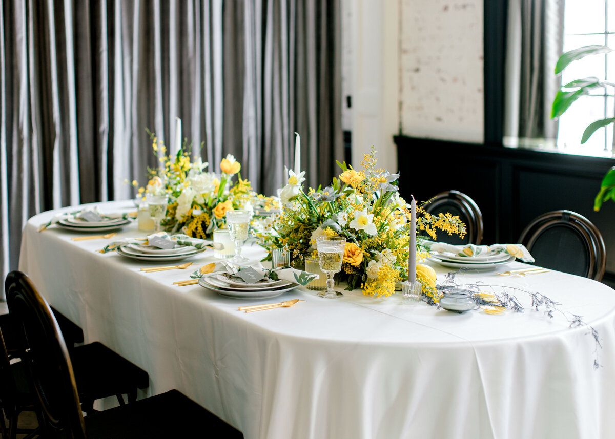 bright yellow flower centerpieces at indoor reception