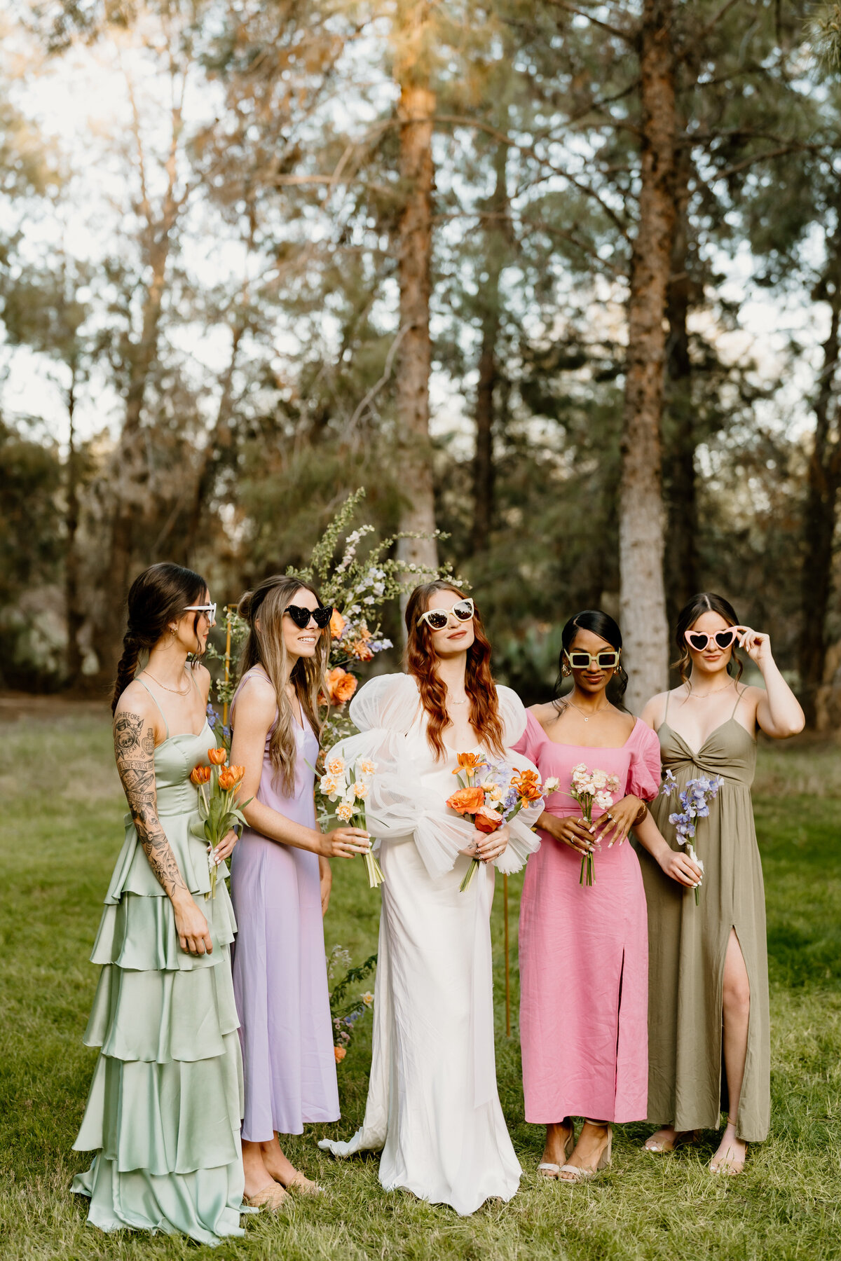 Bride and bridesmaids posing with sunglasses