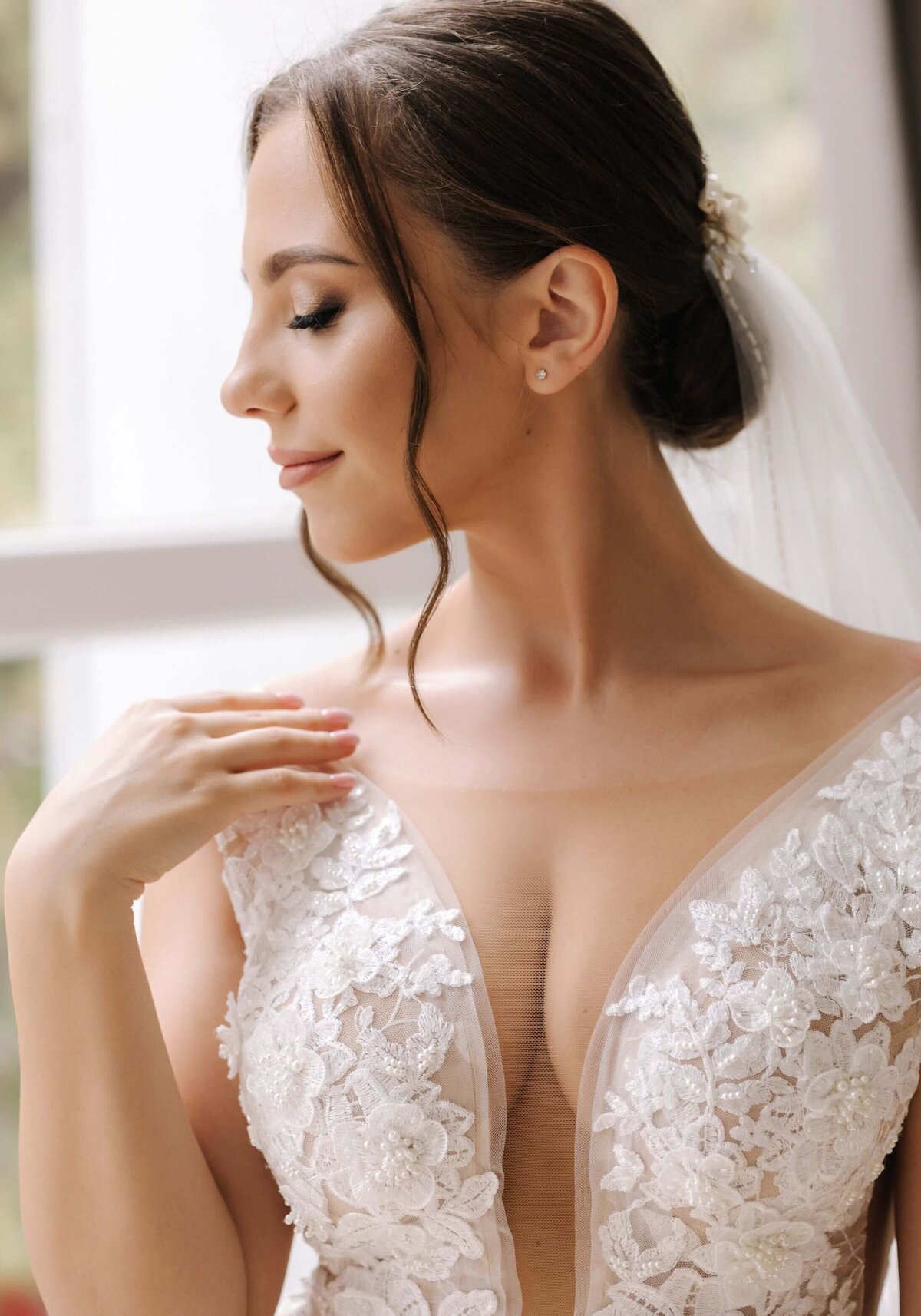 Close-up portrait of elegant woman in luxury wedding dress. Bride morning concept