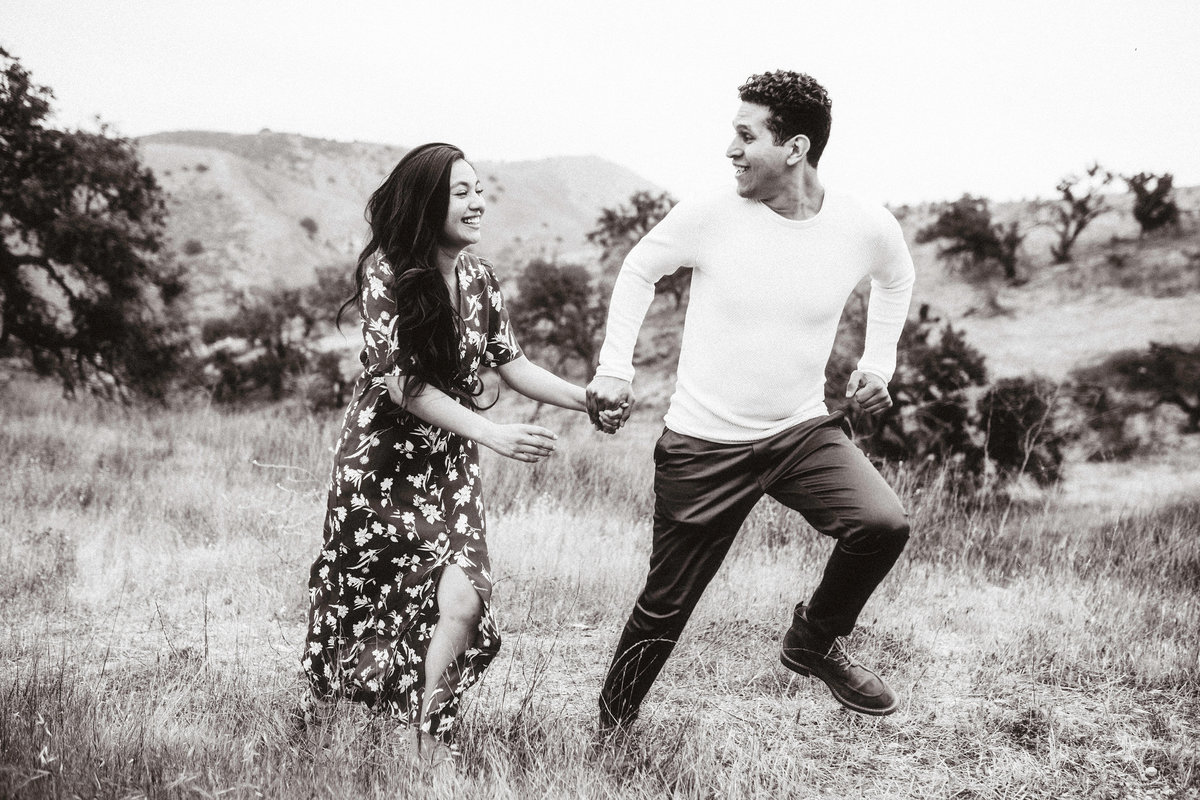 Engagement Photograph Of  Man And Woman Jumping Los Angeles