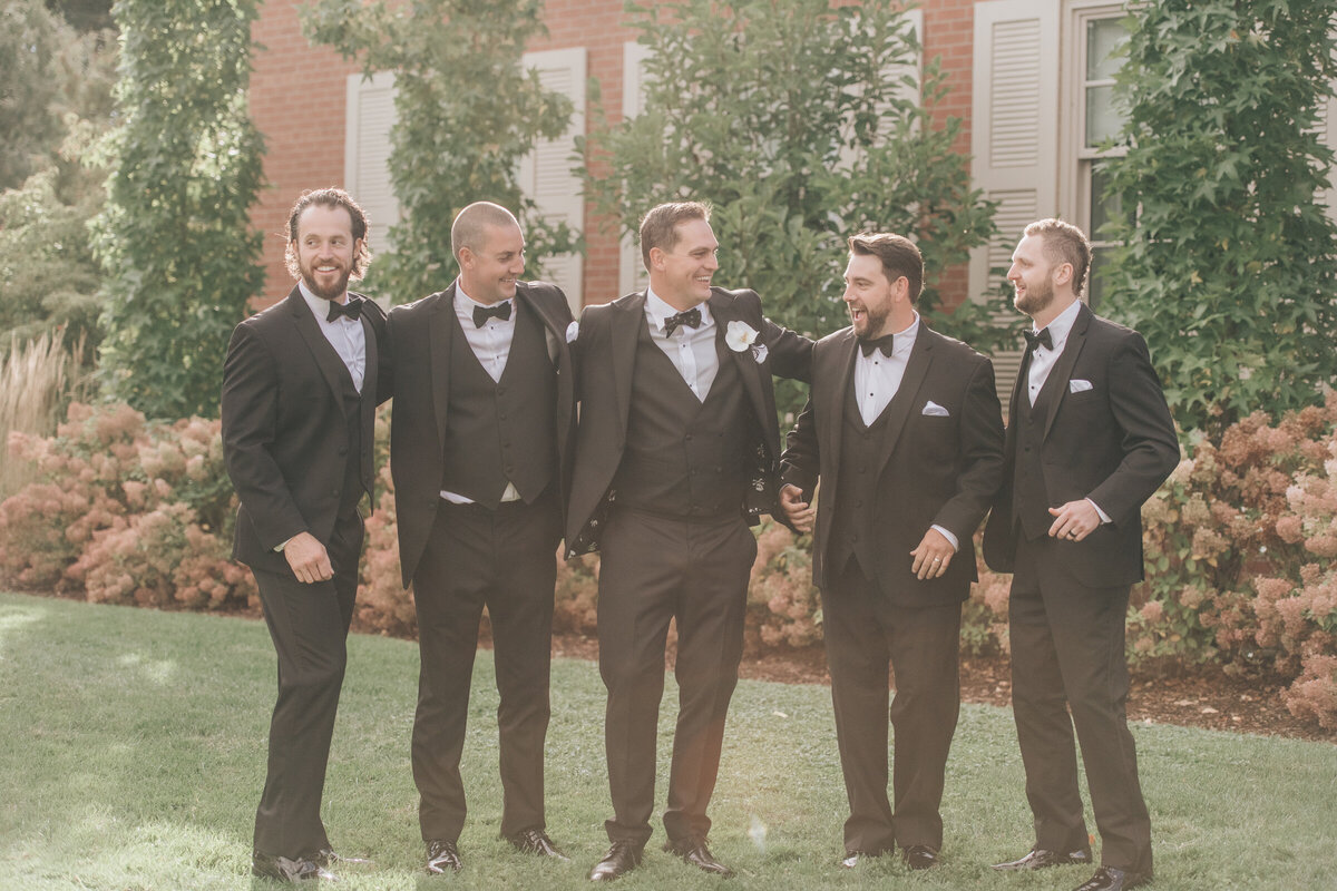 Groomsmen in black tuxedos for traditional groomsmen photos