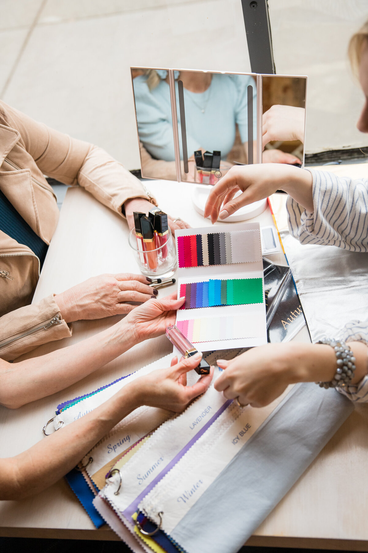Missouri personal stylists flipping through a color swatch book