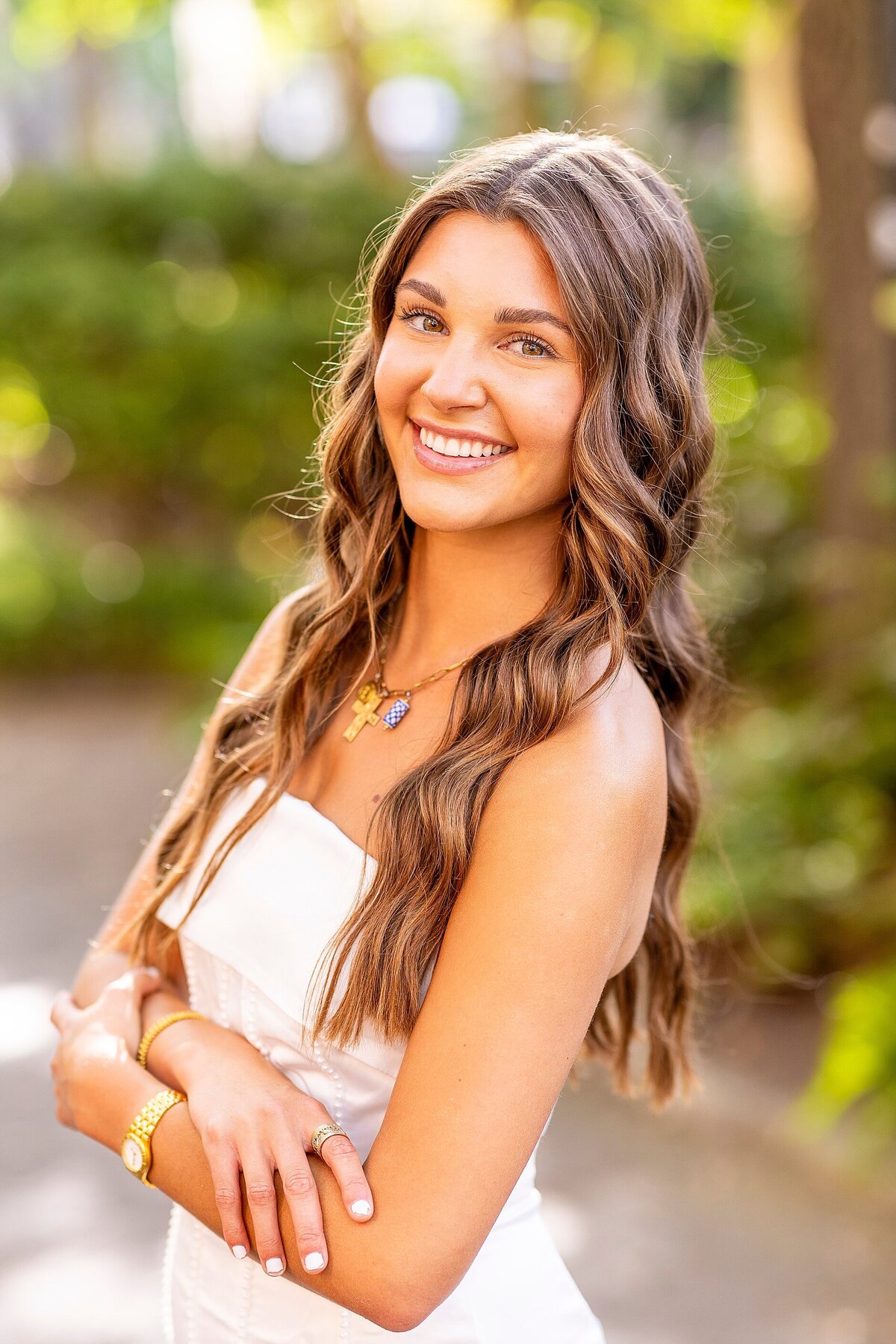 College graduate celebrating achievement at Charleston location in elegant, light-filled portraits