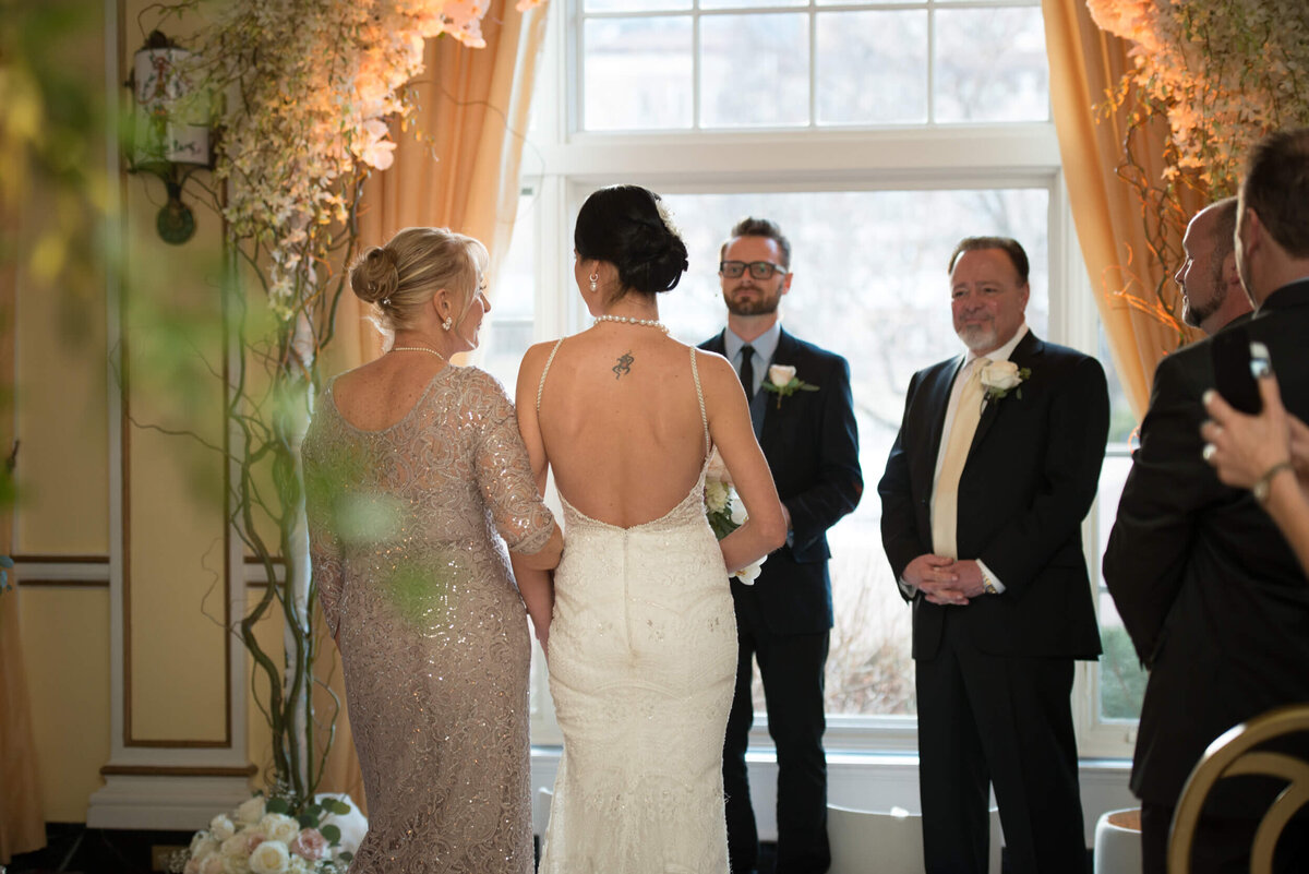 Mother of the bride walks daughter down the isle