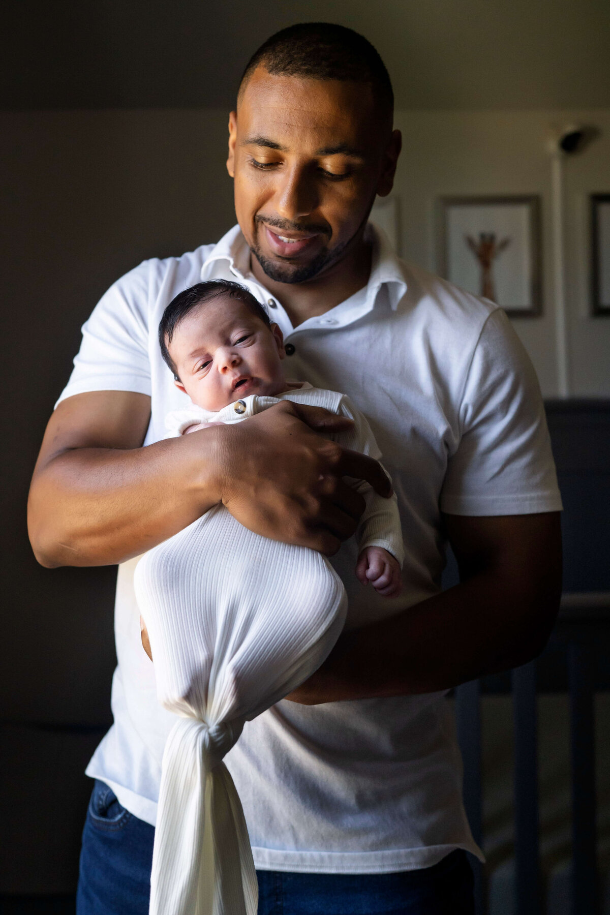 Father holding swaddled newborn boy