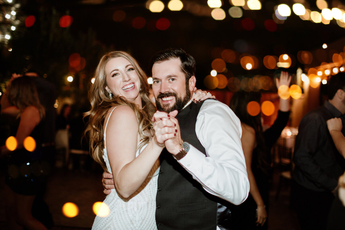 Patio lights light the dance floor for this outdoor first dance captured by Fort Worth Wedding Photographer, Megan Christine Studio