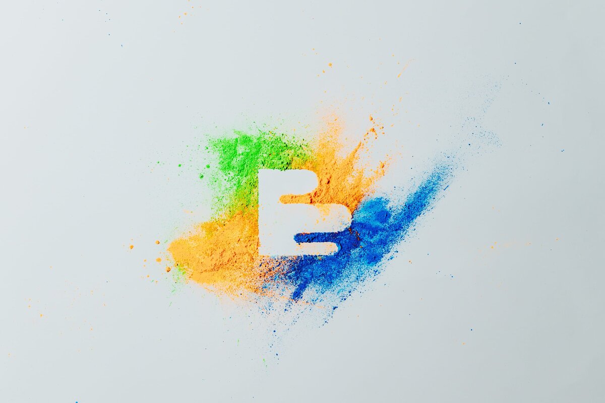 FTC Creative logo is created with vibrantly pigmented green, blue and yellow powder