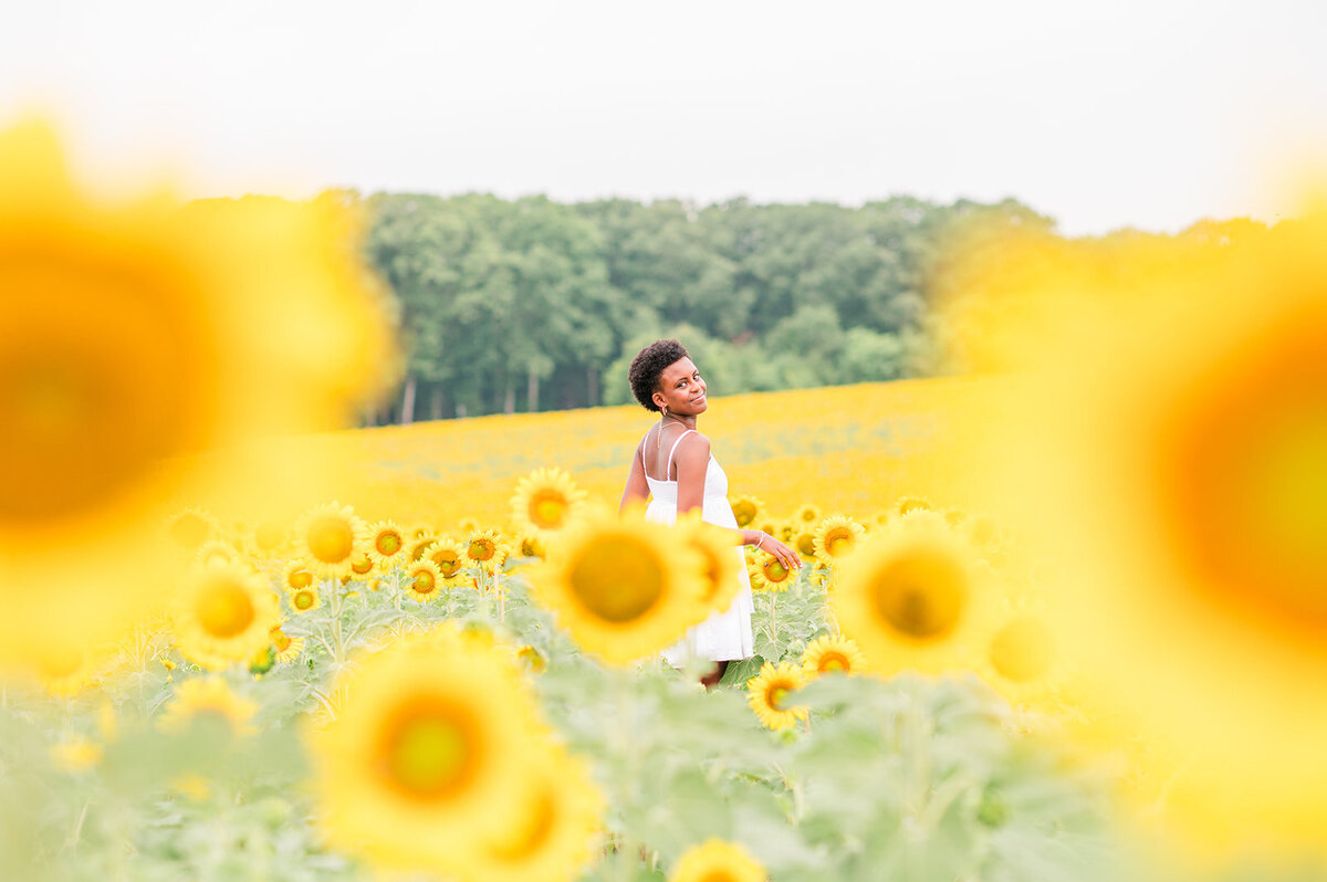 a girl posing in a sunflower field