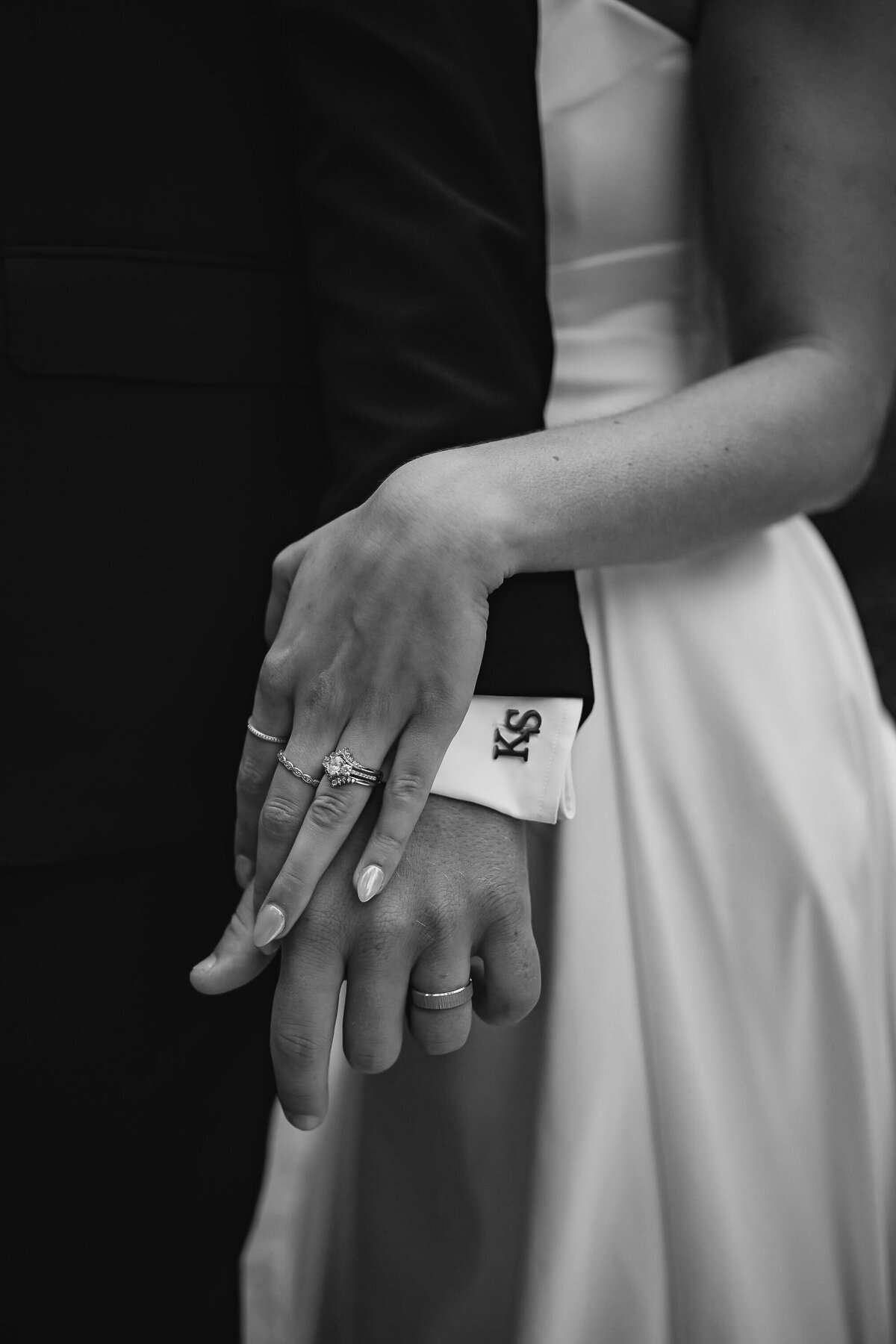 close up image of couples hands and new wedding rings