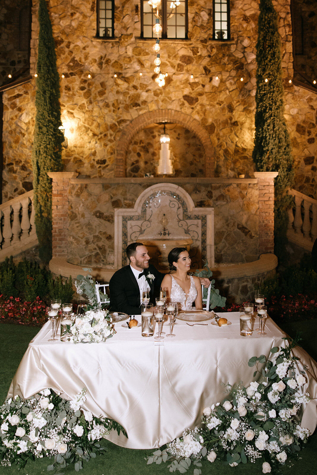 bride and groom listening to speeches at bella collina wedding venue​