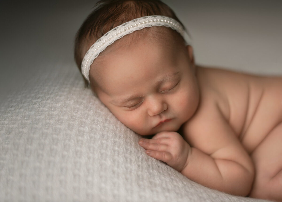 baby with pearl headband by st. louis newborn photographer