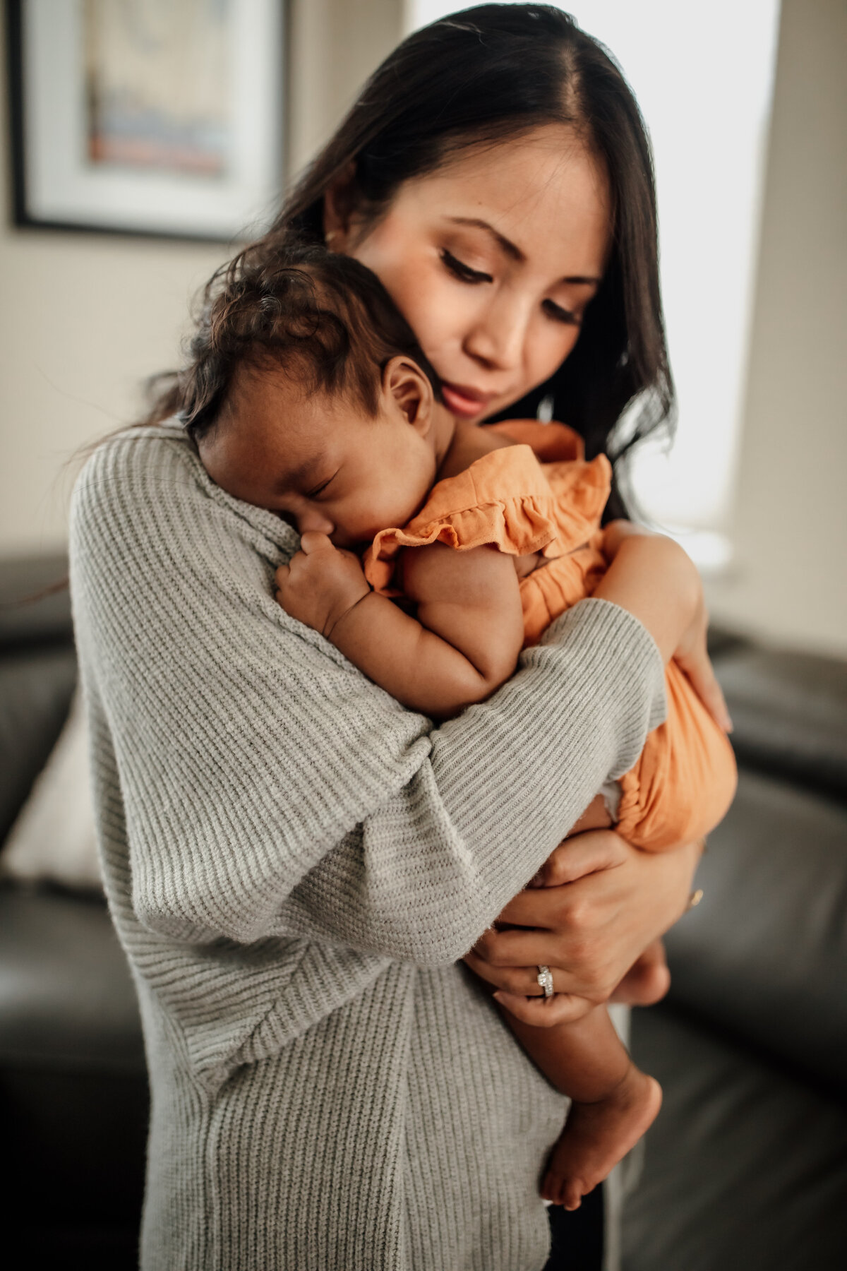 Bay Area mom snuggles baby during in home family photography session