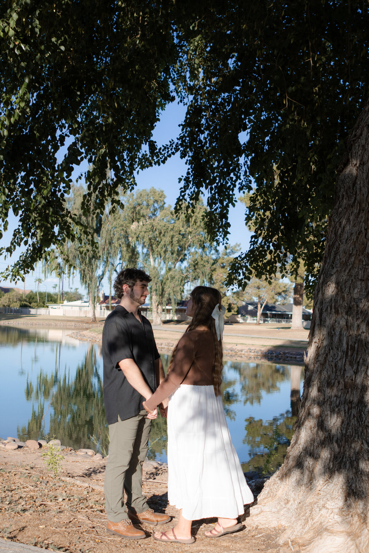 Jovanna G Photography. Classic, sophisticated Wedding Photos. Soft romantic engagement photos. Soft romantic WeddingPhotos. Sophisticated Wedding Photographer. Professional Wedding Photographer. Destination Wedding Photographer. Luxury Wedding photographer. Traveling Wedding Photographer. AZ Wedding Photographer. Gilbert AZ Wedding Photographer. Queen Creek Wedding Photographer. Phoenix Wedding Photographer. Scottsdale Wedding Photographer. Flagstaff Wedding Photographer. SoCal Wedding Photographer. California Wedding Photographer. Northern California Wedding Photographer. Southern California Wedding Photographer. San Francisco Wedding Photographer. Bay Area Wedding Photographer. San Jose Wedding Photographer. Golden Gate Bridge Wedding Photographer. Beach Lover Wedding Photographer. Palace of the Fine Arts Wedding Photographer. Ocean Lover. I love California. Orange County Wedding Photographer. Newport Beach Couples Photographer. Newport Beach Wedding Photographer. Laguna Beach Couples Beach Engagement Photographer. Laguna Beach wedding beach photographer. Los Angeles Wedding Photographer. Young and in love engaged couples who live in southern California. Christian Young Couple. Young Engaged Couple. Engaged High School Christian Couple. Christian Values. Young conservative Christian women. Young Conservative Christian men. Young Conservative Christian Couple. Young Christian Couple Engaged in High School. Young Christian College Couple. Lakeside Lovers in the Autumn Sun. David & Grace - engagement photos. Jovanna G Photographer Engagement Photos. Arizona sun shining through autumn trees- engagement. Chandler, AZ Engagement Photos. Chandler, AZ 2026 bride. Chandler, AZ Wedding Photographer. Chandler, AZ Young Engaged Couple. Girl in her 20s. Engaged Arizona Girl in her 20s. Lakeside Engagement photos. AZ Lakeside Engagement Photos. AZ Weeping Willow Lakeside Proposal. Arizona Lakeside Proposal with weeping willow tree. Detail shot of engagement ring on Arizona Lakeside estate. Chandler, AZ Lakeside Estate Proposal Outfit Inspiration.