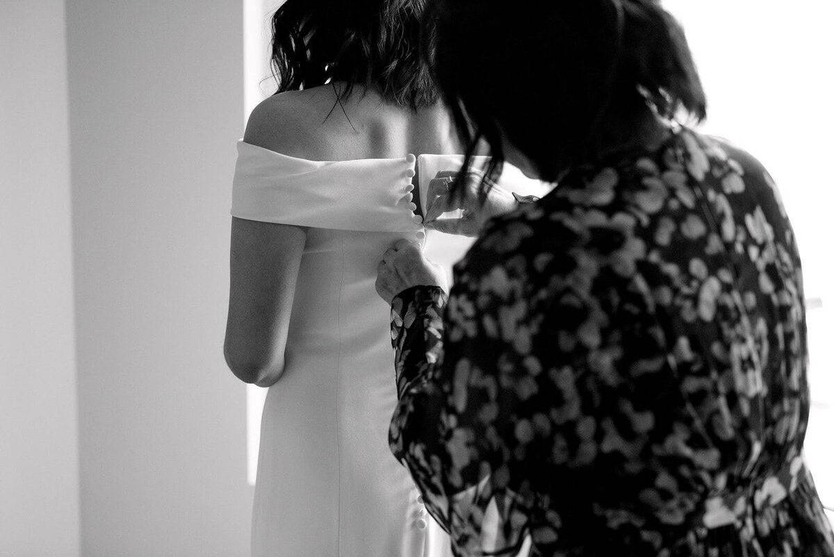 Modern Editorial Bride Slips into Wedding Dress with Mother Candid Moment Toronto Wedding Jacqueline James Photography