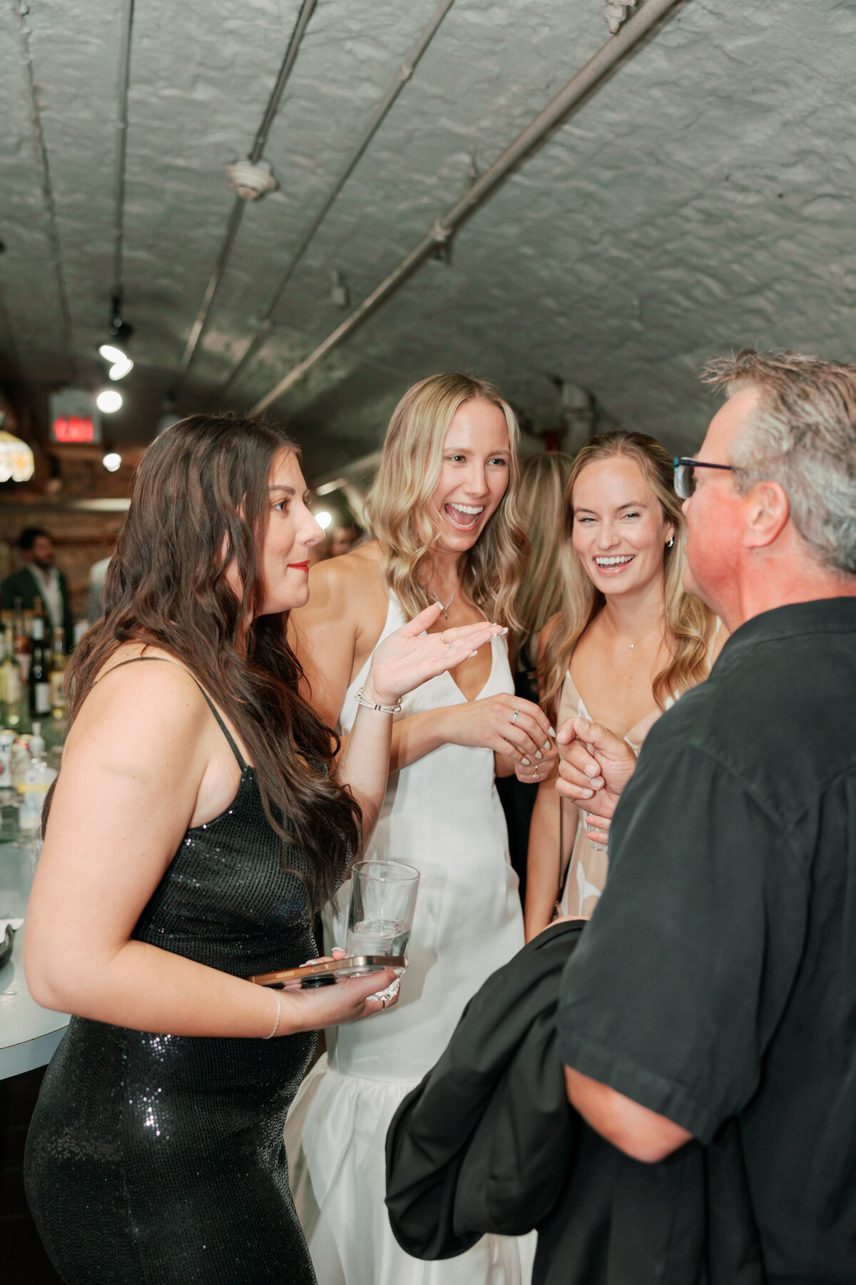 Bride and groom celebrate with guests after ceremony by Philadelphia wedding photographer.
