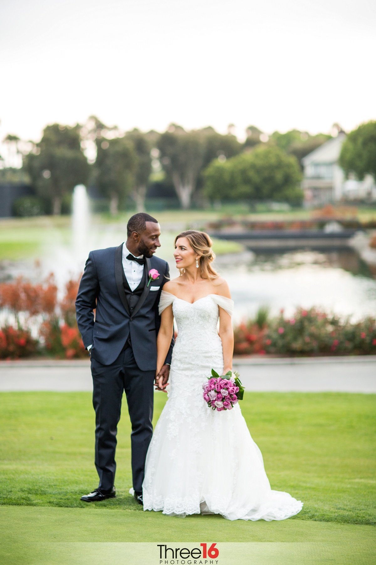 Bride and Groom look at each other on the golf course of the SeaCliff Country Club