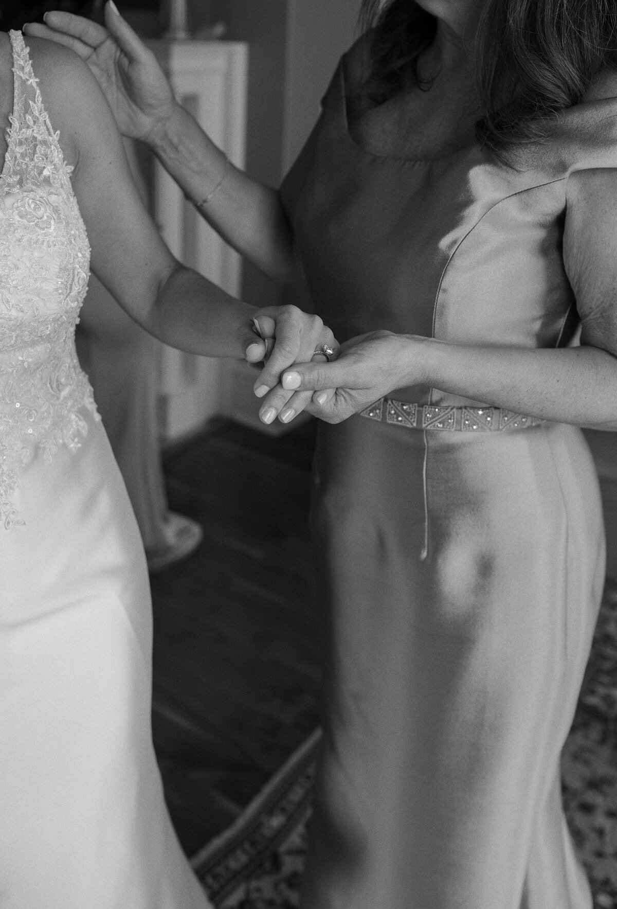 Bride's mother holds her hand as she gets ready for wedding at The Chanler, Newport.