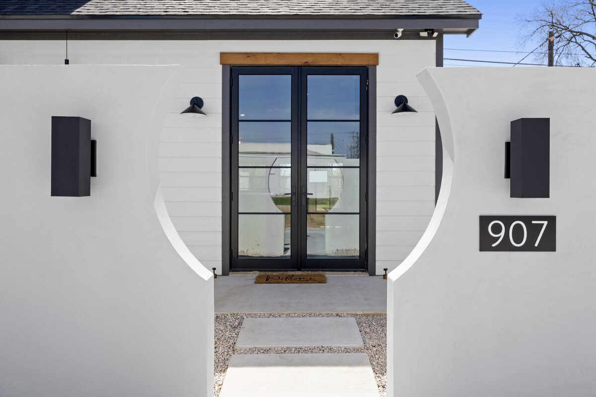 Elegant front door view at this two-bedroom, two-bathroom house with wine fridge, firepit, and two master suites located in the heart of the Silo District in Waco, TX.