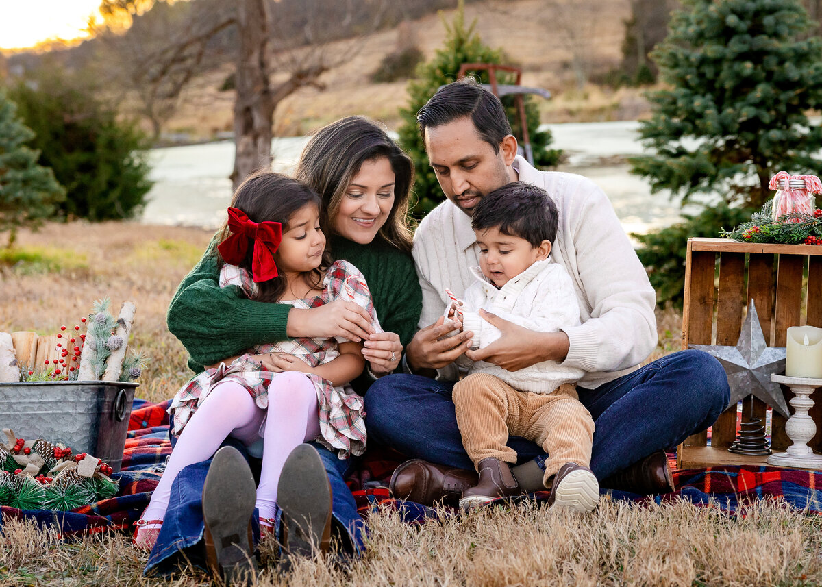 Family photo on a blanket decorated for the holidays at a Christmas tree farm in Somerset County, NJ