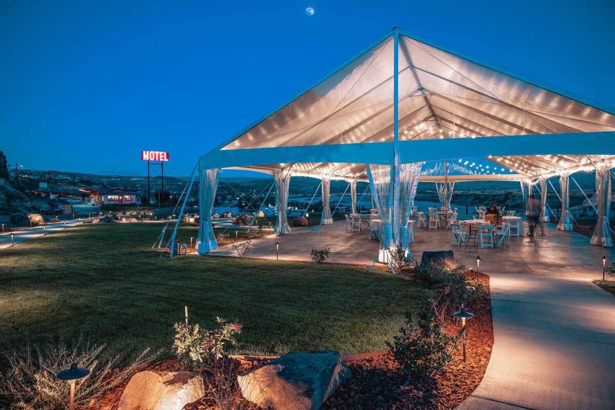 White tent  with lights at night at Celilo wedding venue