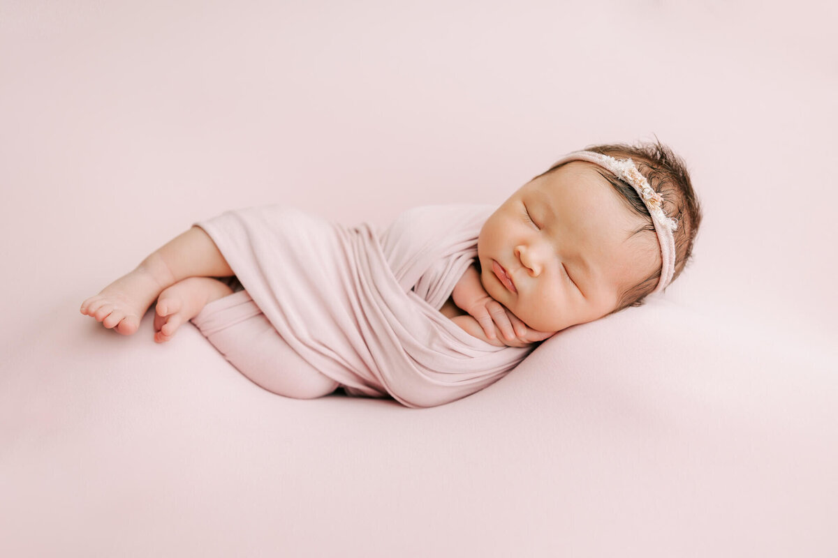 infant on pink blanket for her photography session with ann marshall photography
