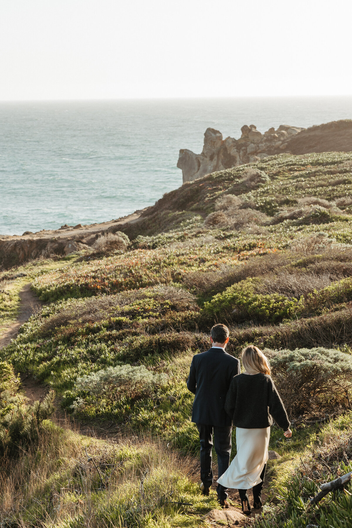 Sonoma county photographer captures couple walking towards ocean in jenner california