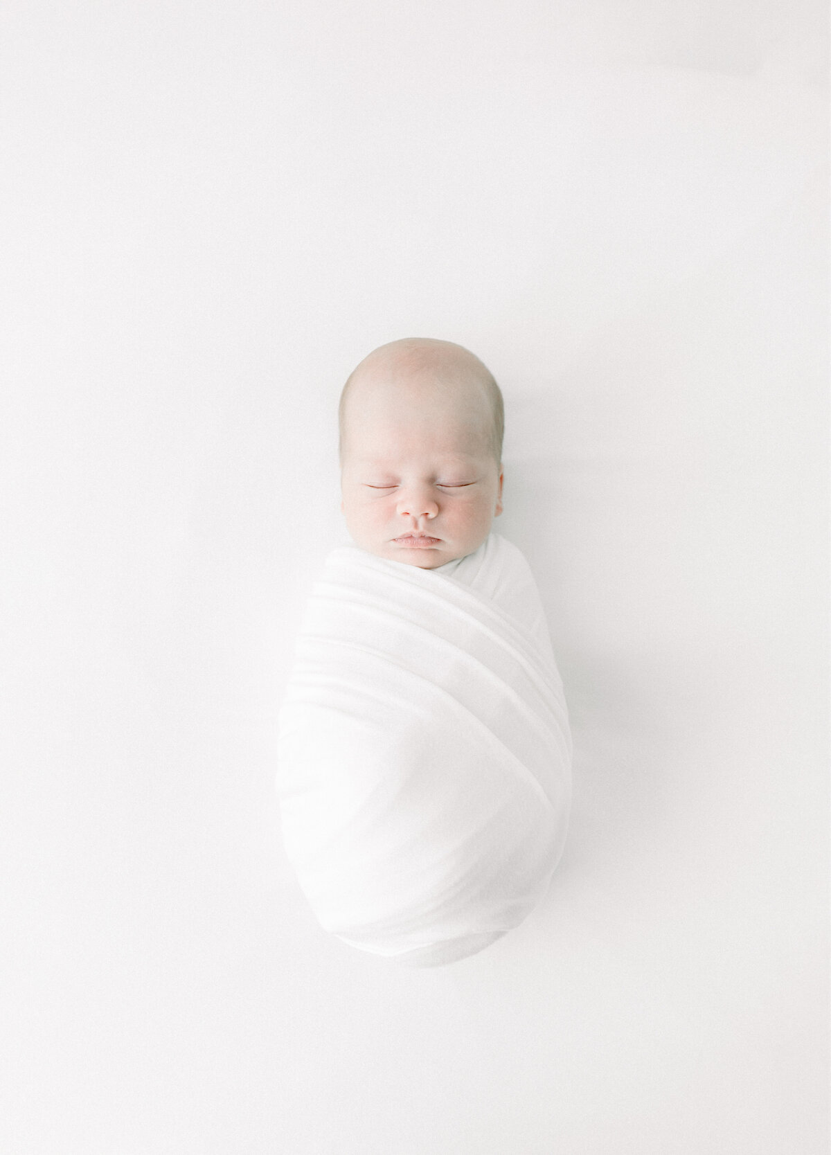 A newborn baby wrapped and laying down