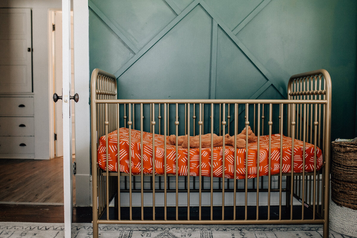 Baby room with wooden crib.