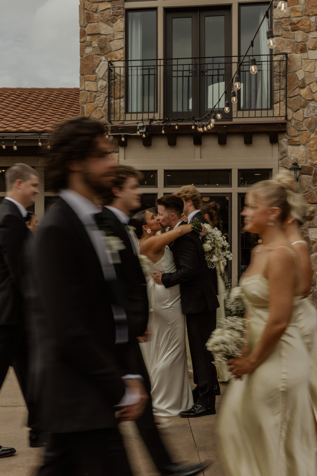 Wedding Couple Kissing in front of venue 
