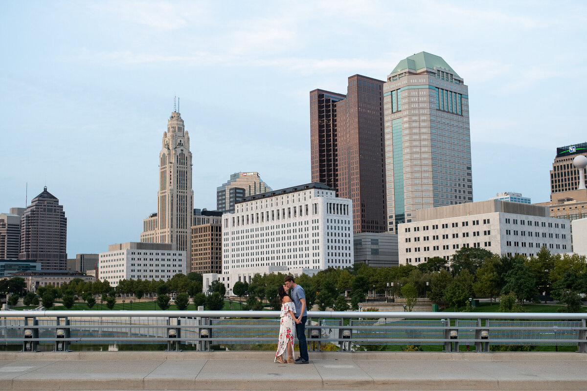 Couple kisses during sunset in front of the Columbus skyline