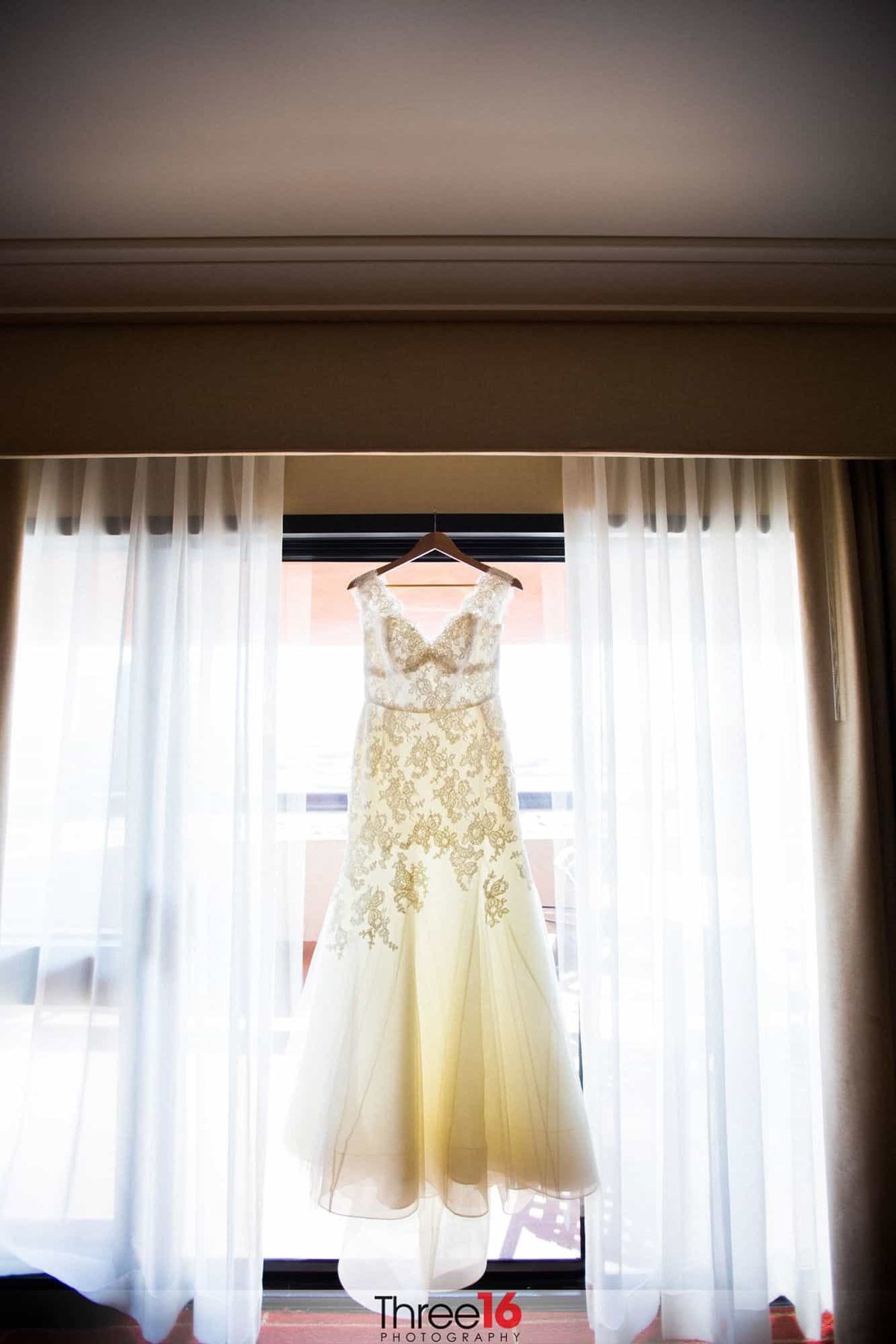 Bride's beautiful wedding dress hanging on display