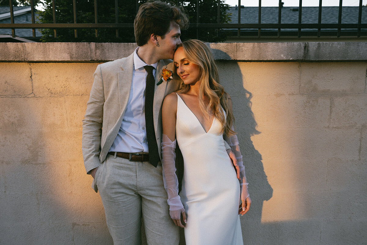 Groom and bride during golden hour portraits in the downtown urban space of Nashville, TN.