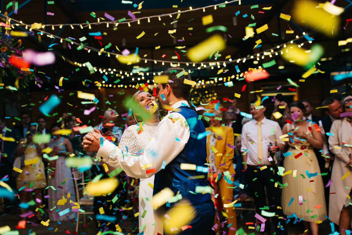 Confetti falling as the newly weds have their first dance