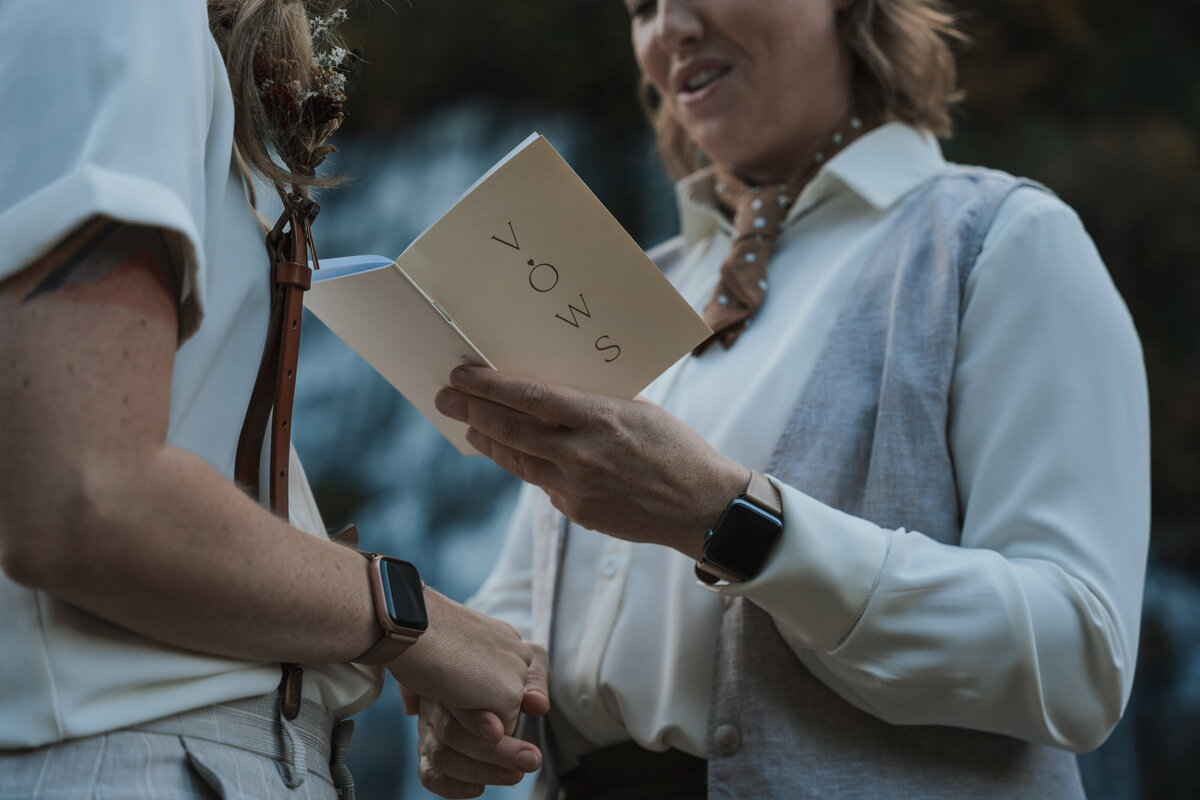 Woman reads her vows from a notebook 