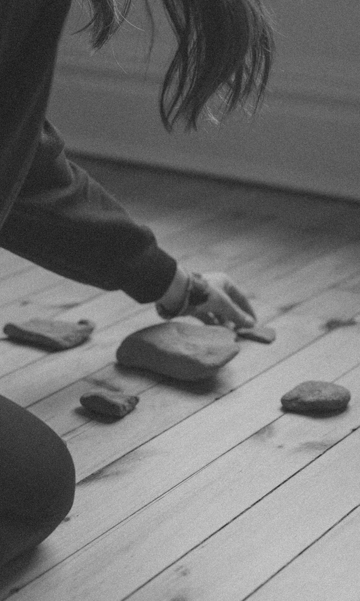 Tanner intentionally placing a stone during the Rock Creek Ritual, symbolizing the anchoring of new beginnings and sacred intentions in the FUTURE Directional Calling.