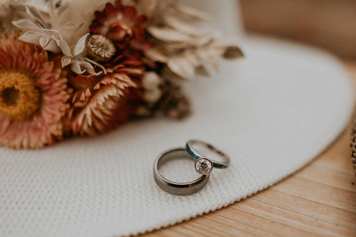 bride and grooms southwest turquoise wedding bands together