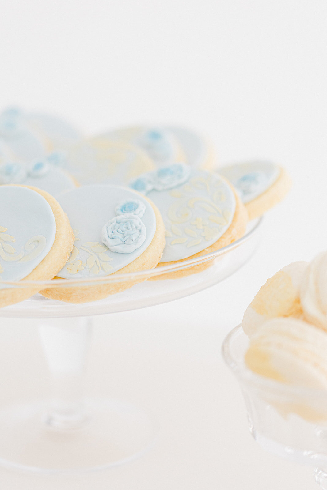 Platter of shortbread biscuits and macarons on a wedding dessert table