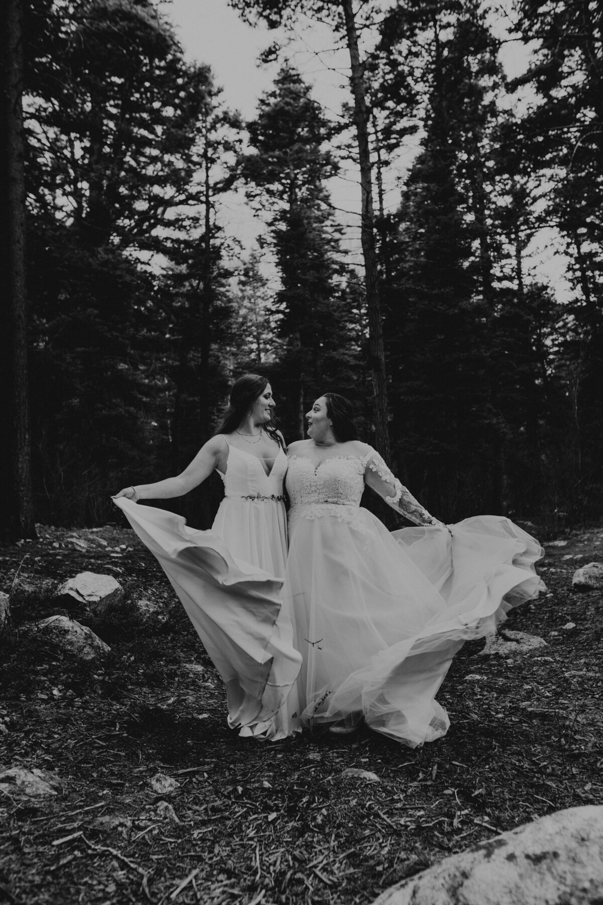 two brides spinning gowns together