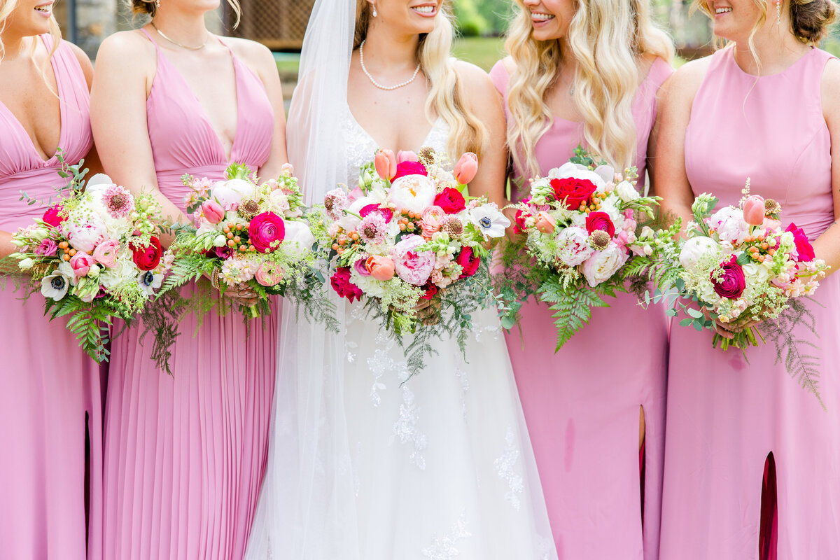 wedding bouquets held by bride and bridesmaids in pink dresses