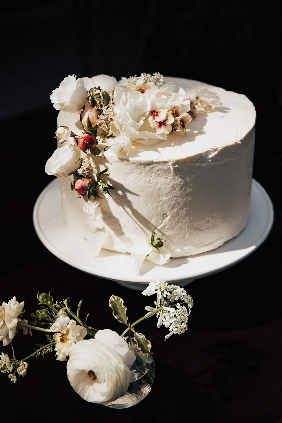 White luxury wedding cake with floral arrangement