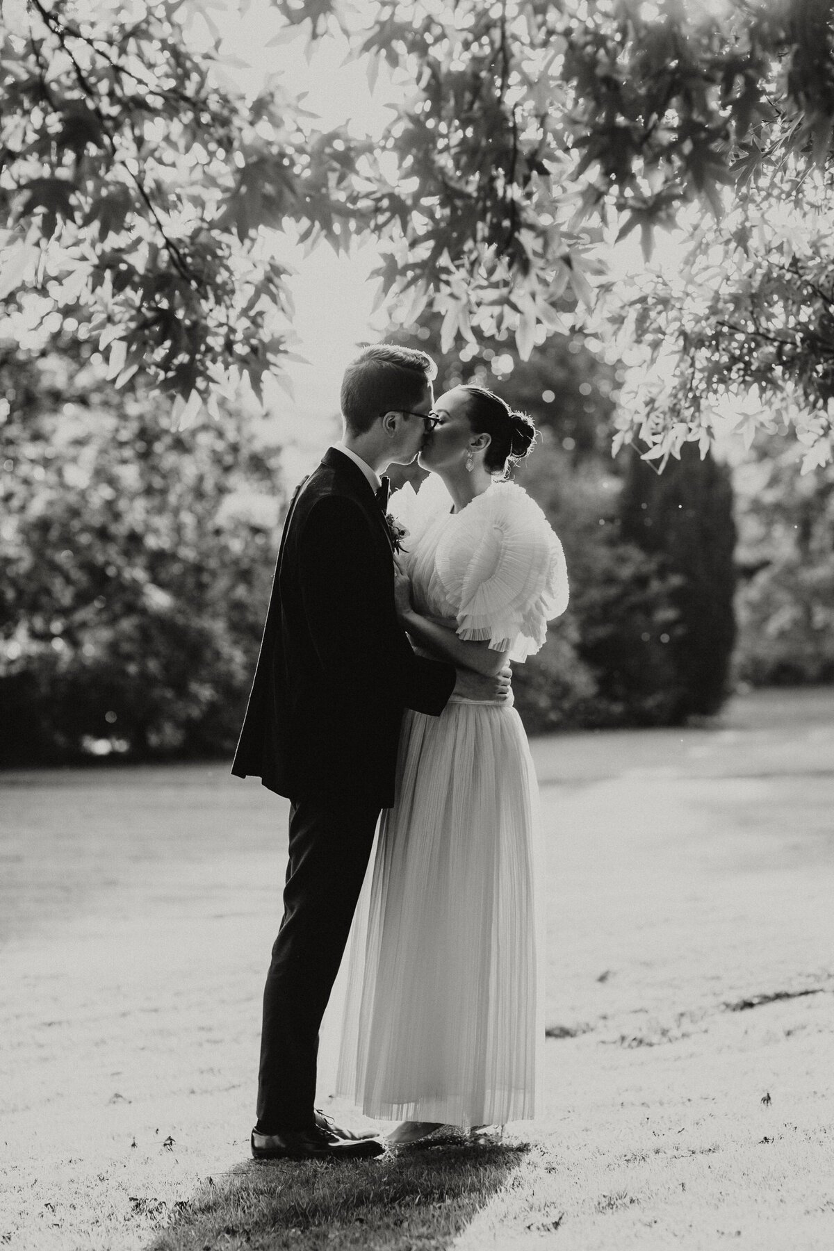 Black and white portraits of Couple embracing in Devon Gardens 