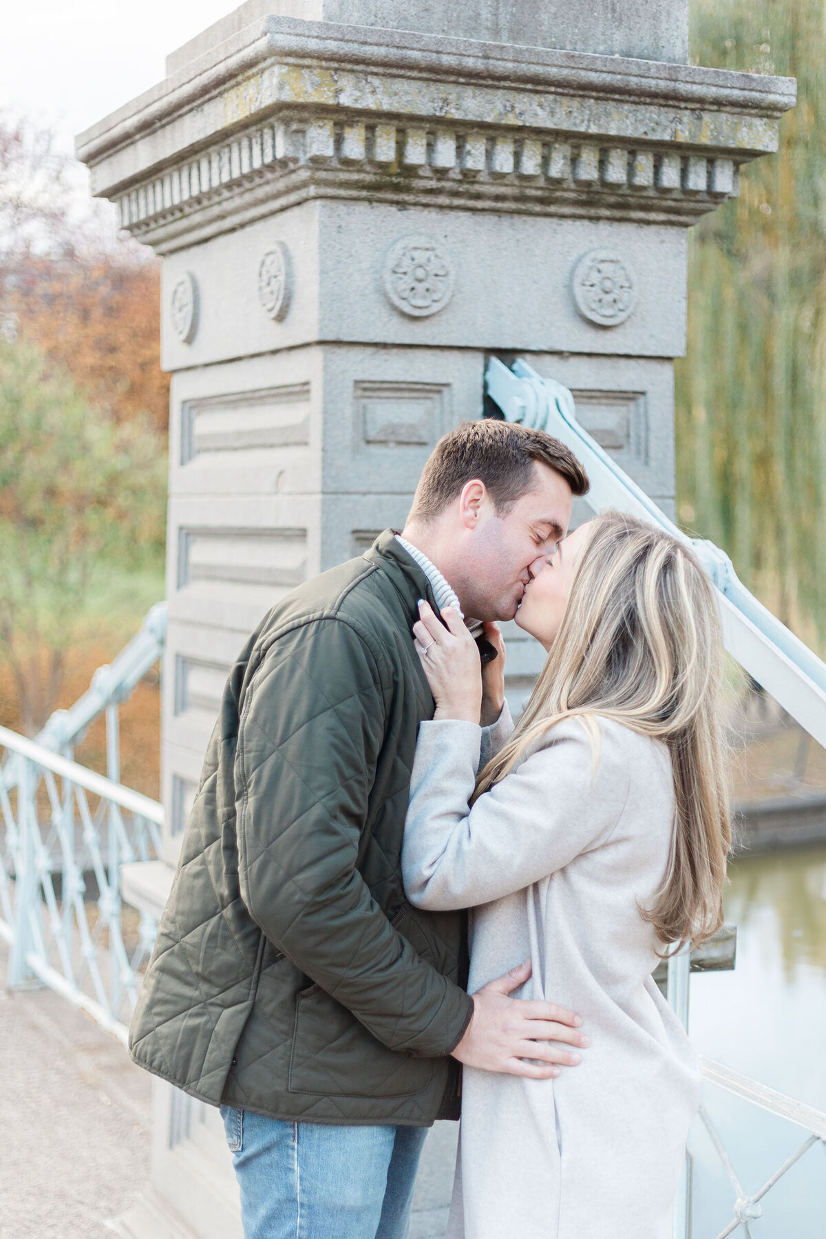 A couple kiss on the bridge of the Boston Public Gardens