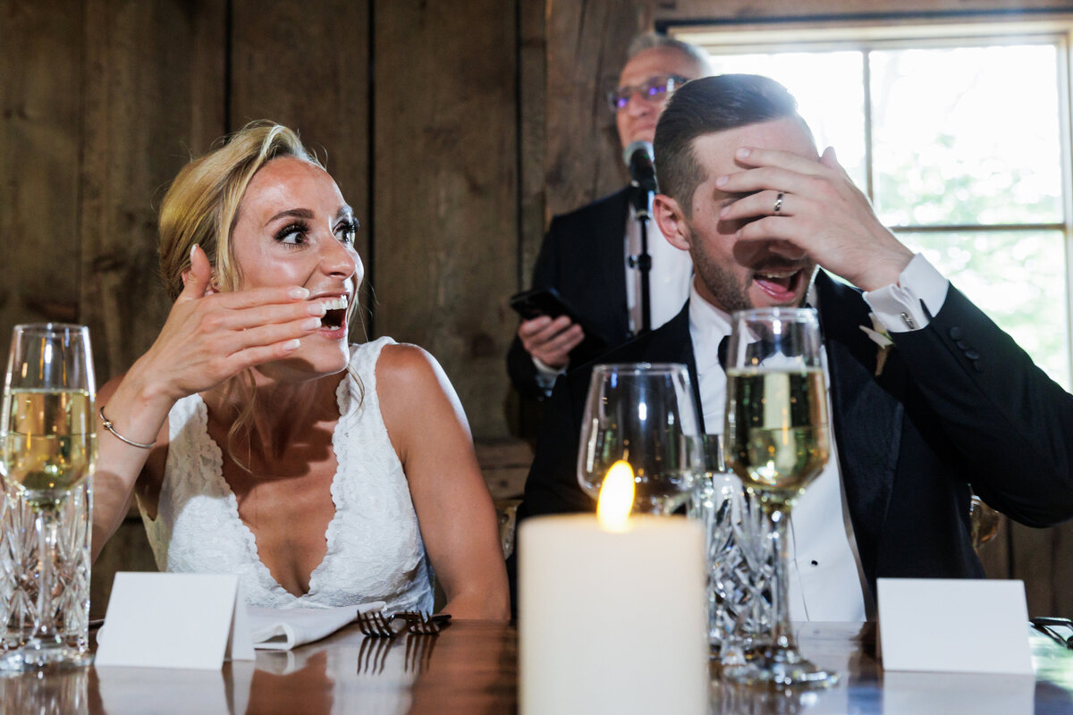 Couple reacts to a toast from her father at Cunningham Farm Maine