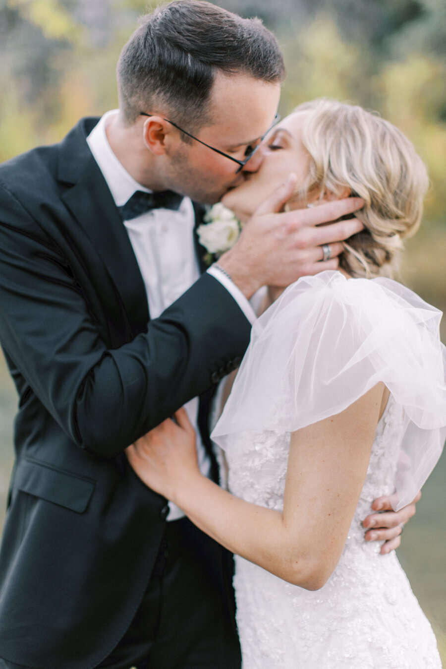 bride and groom kissing  during the photography session on their Calgary wedding day