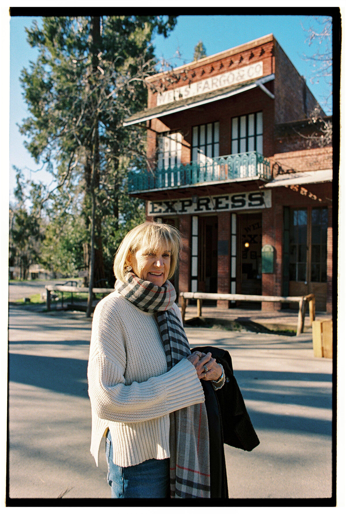 Backlit portrait of a woman captured on film by Kate Winters Photography, showcasing an authentic and candid moment in Carmel, California.
