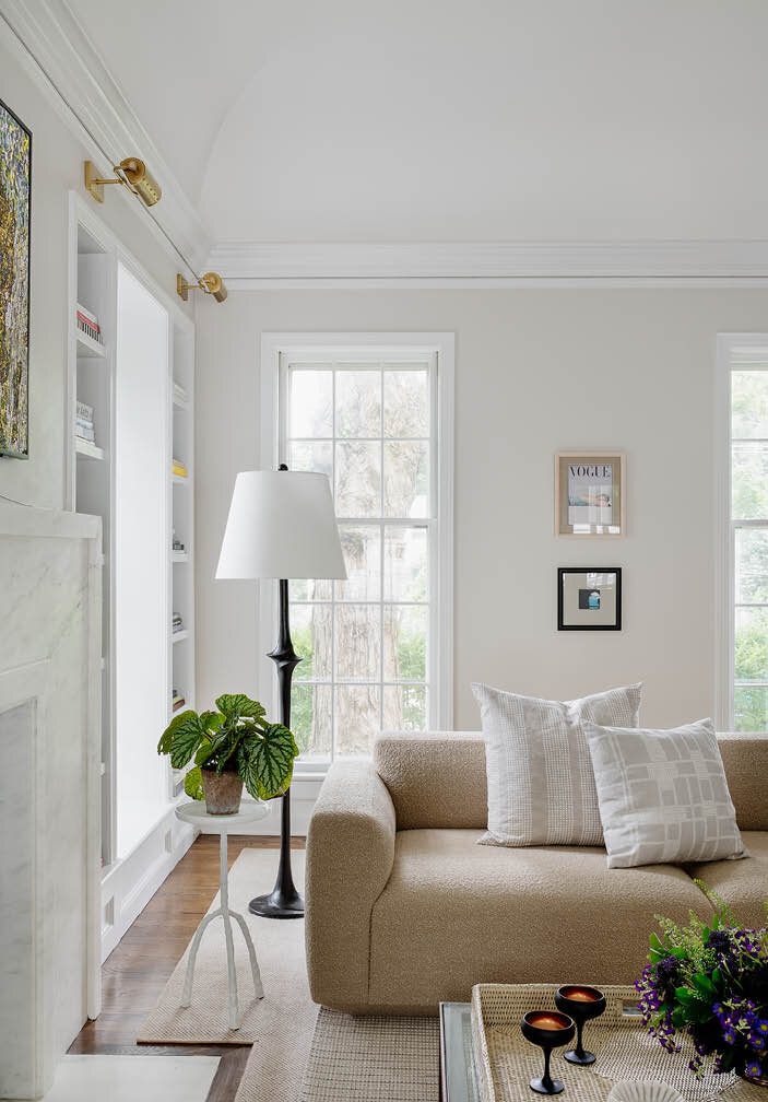 Check out the side view of the &Tradition sofa paired with a Made Goods side table and a Visual Comforts floor lamp, adding a touch of sophistication to the space.