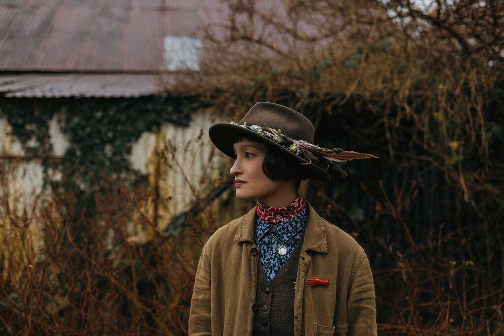 Portrait of Devon based print Artist Rachel Snowdon in her garden at home