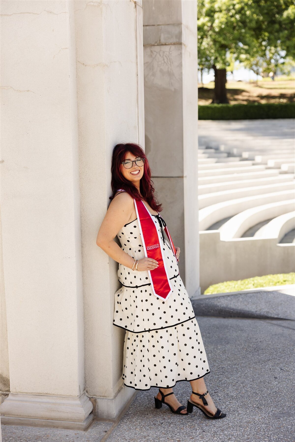 Playful Graduation Portrait in Polka Dot Dress at Arkansas Campus